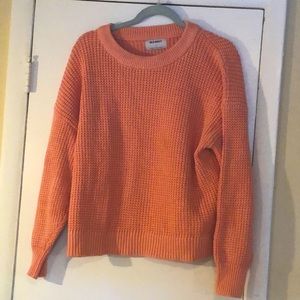 Knit spring sweater in salmon pink.